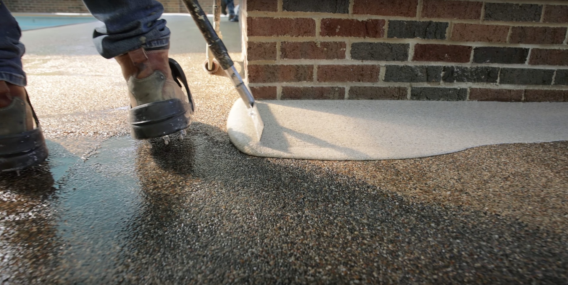 Professional concrete finishing techniques and tools Professional concrete installation with finishing tools and wet concrete surface