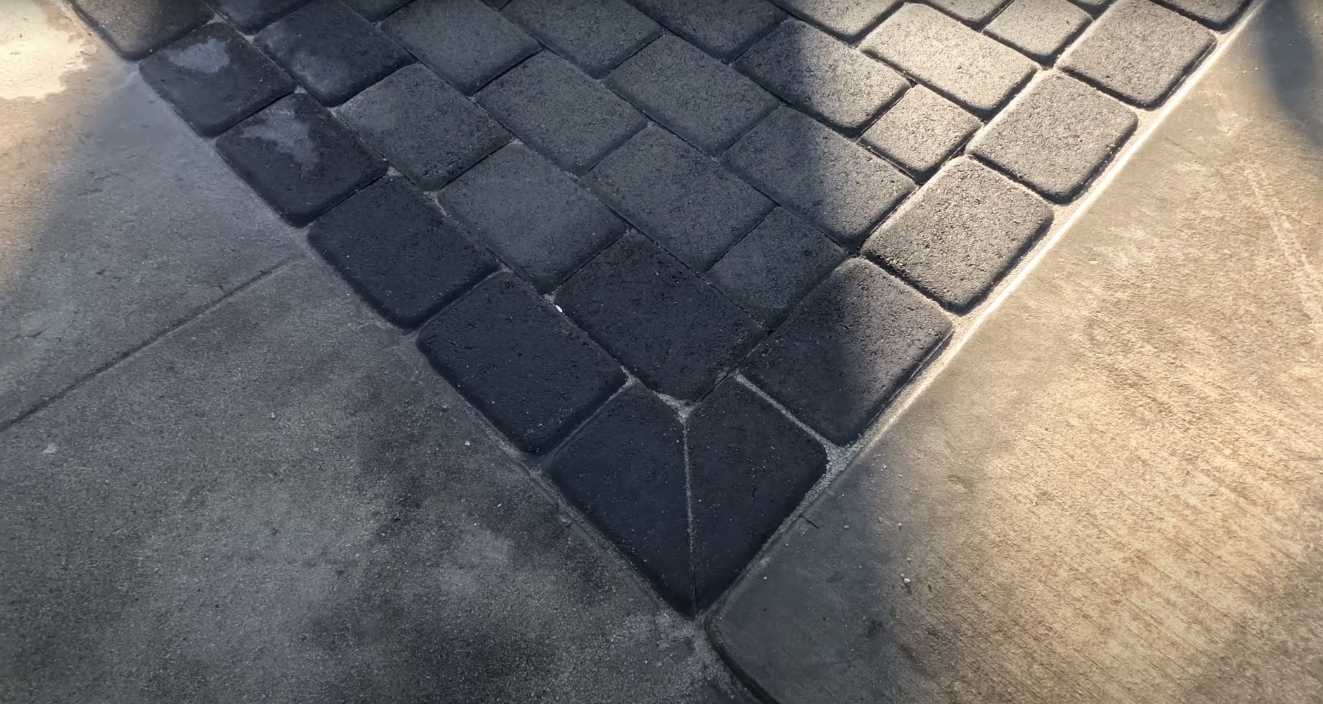 Decorative concrete paver installation in herringbone pattern Decorative concrete pavers arranged in herringbone pattern installation