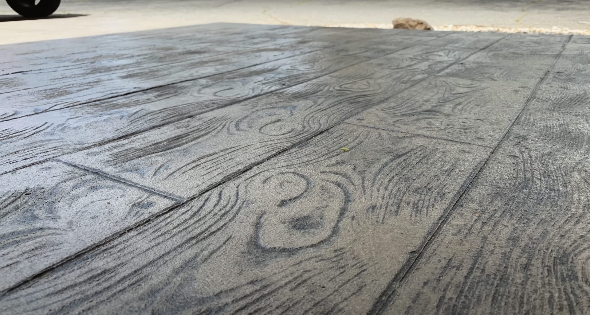 Decorative stamped concrete patio with wood grain pattern Stamped concrete patio with decorative wood grain pattern texture finish